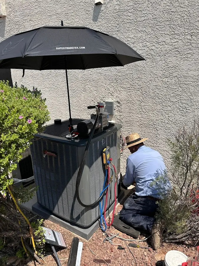 HVAC technician performing outdoor AC maintenance in Lugoff