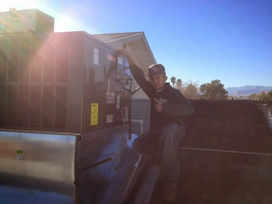 HVAC technician performing AC Tune-Up on a rooftop unit in Lugoff